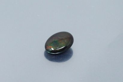 null Oval cabochon black opal on paper.

Accompanied by a GIA certificate indicating...