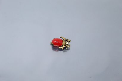 null Broche en métal doré stylisant un scarabet orné d'une pierre rouge cabochon...