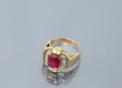 null 18k (750) yellow gold ring set with a synthetic ruby in a pavement of brilliants....