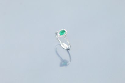  18K (750) white gold ring set with a pear-shaped emerald surrounded and shouldered...