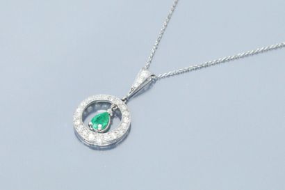 null Circular platinum pendant set with 8/8 cut diamonds holding a pear cut emerald...
