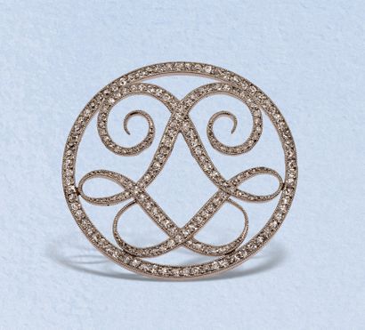  CARTIER Paris 
Monogrammed openwork platinum circular brooch featuring two interlaced...