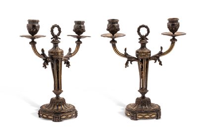 null A pair of silver (950) and ivory two-light candelabra. The round base with channels,...