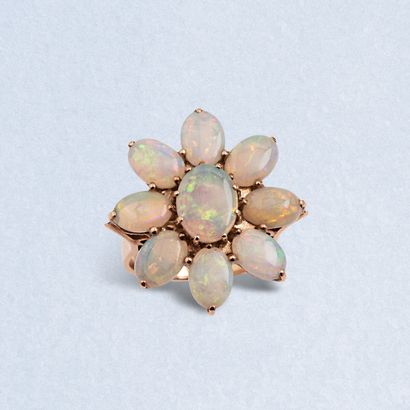  9K (375) yellow gold "flower" ring set with oval white noble opals. 
Finger size:...