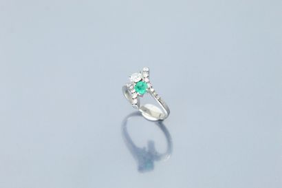  18K (750) white gold ring set with a round emerald and an old-cut diamond between...