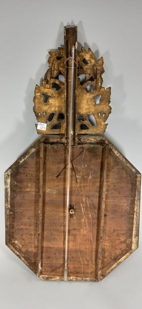 null Carved and gilded wood barometer of octagonal shape.

Framed with a frieze of...