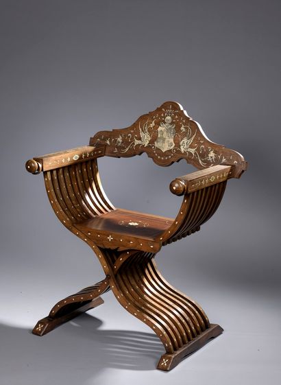 null Curved armchair called Savonarola in walnut inlaid with bone(?) engraved. The...