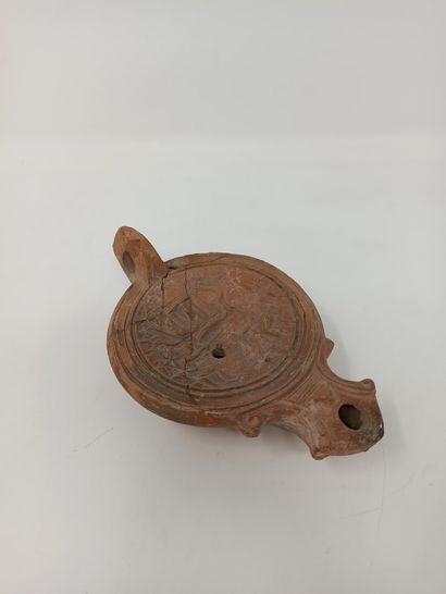 null Oil lamp with square scroll spout. The medallion shows a rare scene of fishermen...