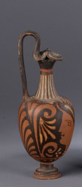 null Oenochoe with three-lobed spout painted with a female head in profile left

Under...