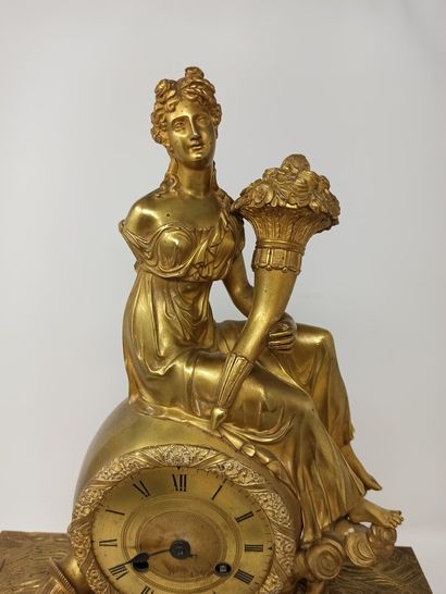 null Abundance clock

in gilded bronze, consisting of a high base decorated with...