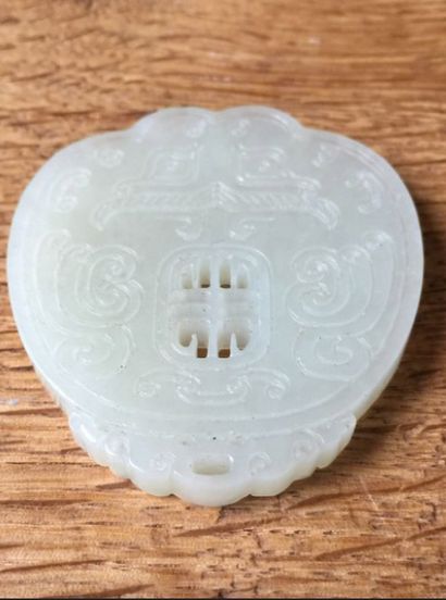 null CHINA - 20th century

Celadon nephrite pendant with a taotie mask in light relief...