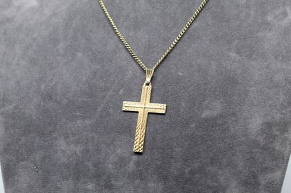  18k (750) yellow gold forçat chain. 
A cross pendant in 18k (750) yellow gold with...