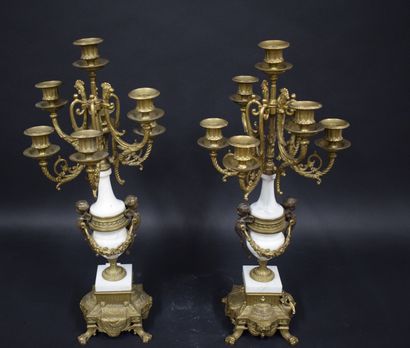 null 
A pair of bronze candelabra decorated with putti, white marble base.





Work...