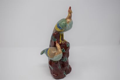 null Two porcelain groups, 20th century China:

- Two peacocks on a polychrome rock...