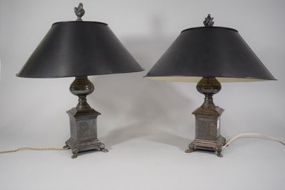 null 
Pair of silver plated metal lamps with foliage decoration, the shafts rest...