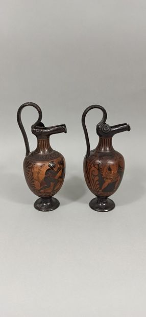 null Lot of two oenochoes with a spout and a high rigid handle. The scenes present...