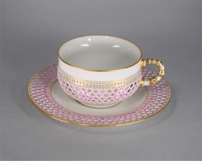 null SEVRES 

Cup whose handle simulates the bamboo and its saucer in reticulated...