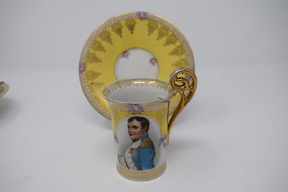 null Two cups and saucers, 

One with a yellow background decorated with a portrait...