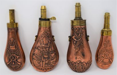 Four brass and copper embossed powder flasks...