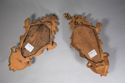 null A pair of small carved and gilded wood mirrors, forming sconces, a metal candle...