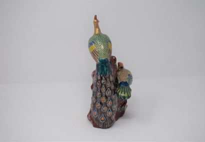 null Two porcelain groups, 20th century China:

- Two peacocks on a polychrome rock...