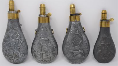 null Four brass and zinc embossed powder flasks with cygetic decoration :

- a pair...