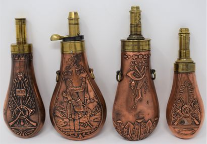 null Four brass and copper embossed powder flasks with cygenetic decoration :

-...