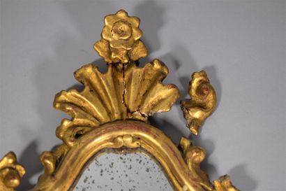 null A pair of small carved and gilded wood mirrors, forming sconces, a metal candle...