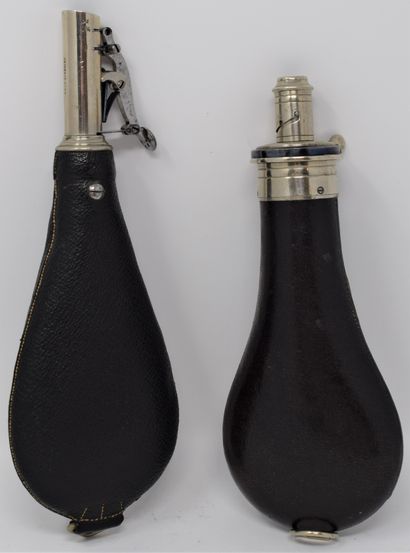 null Two leather piriform powder flasks:

- one signed Boche in Paris, a suspension...