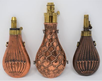 null Three brass and copper embossed powder flasks with hot air balloon decoration:

-...