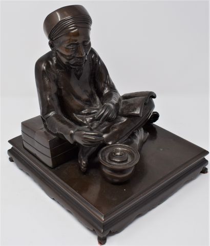 null Bronze group with brown patina resting on a rectangular terrace showing a scholar...