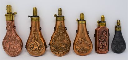 null Six powder flasks in embossed metal with cygenetic decoration (game) and brass...