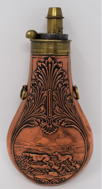 null Three brass and copper embossed powder flasks with cygetic decoration, with...
