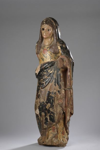 null 
Polychrome wood sculpture representing a woman draped in a garment with floral...