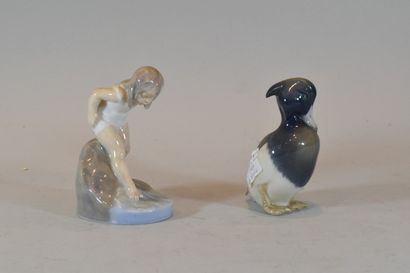 null Two Royal Copenhagen porcelain subjects representing a bent child and a duck...