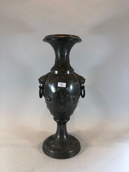 null A large metal vase decorated with grapevines, lion heads,

H.:60 cm