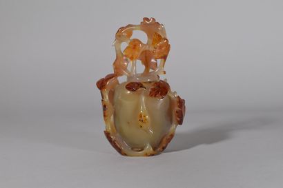 null CHINA, 20th century

A cornelian agate covered vase, carved in the round with...