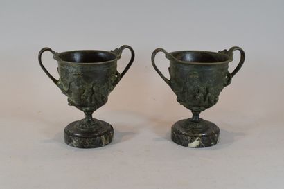 null A pair of bronze cups decorated with lovebirds resting on a pedestal 

Base...