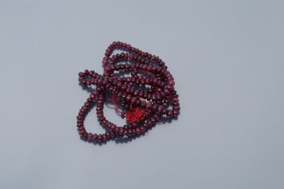 Ruby beads strung on a red thread. No clasp....