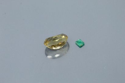 null Lot including a rectangular emerald and an oval citrine. 

Weight of the emerald...