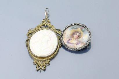 null Lot including a large metal pendant with a conch cameo and a round polychrome...