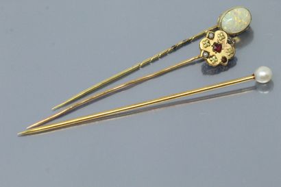 null Set of three 18K (750) yellow gold tie pins, one with a cabochon opal, another...
