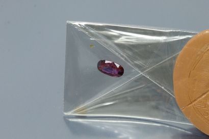 Oval ruby under seal. 

Accompanied by a...