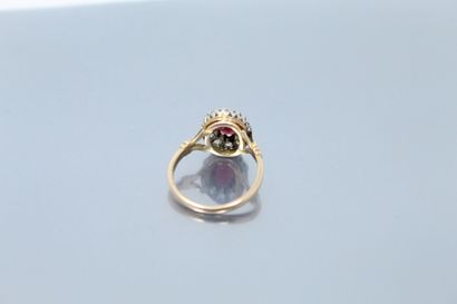 null 
18k (750) yellow gold and platinum ring set with an oval ruby in a pink diamond...