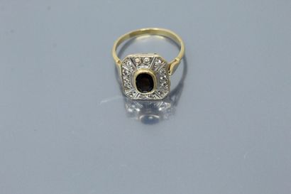  18K (750) yellow gold ring set with an oval sapphire in a circle of diamonds. 
Marked...