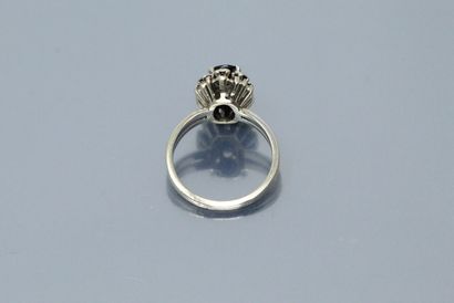 null 18k (750) white gold ring set with an oval sapphire in a diamond setting. 

Finger...
