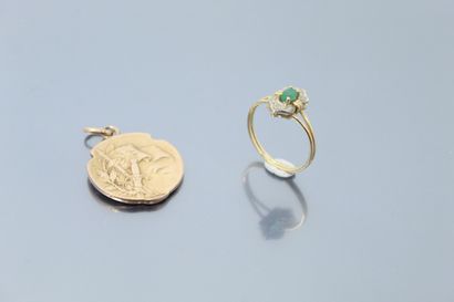  An 18k (750) yellow and white gold ring with an oval emerald and an 18k (750) yellow...
