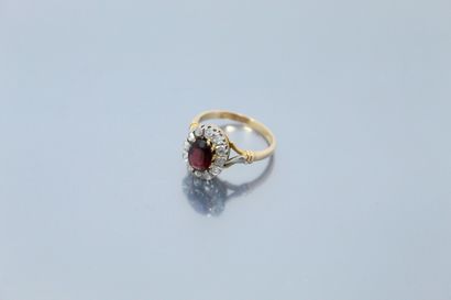  18k (750) yellow gold and platinum ring set with an oval ruby in a pink diamond...