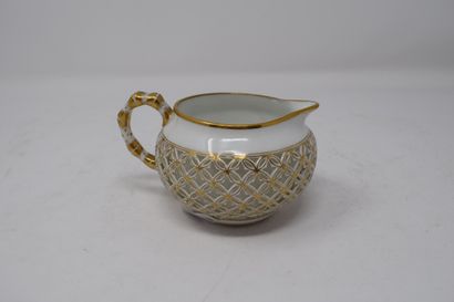 null 
SEVRES 

Milk pot in reticulated porcelain whose handle simulates the bamboo,...
