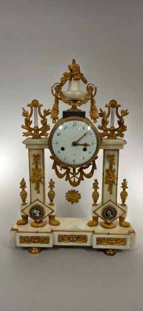 null White marble and gilt bronze clock of portico form, the dial with Arabic numerals,...